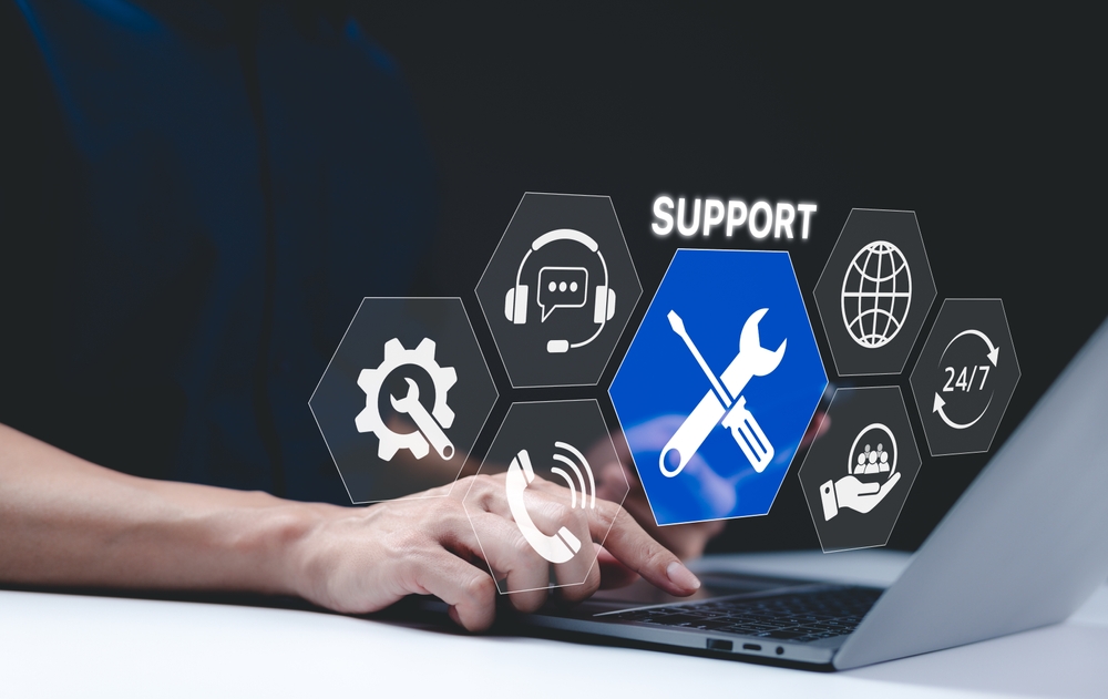 A person using a laptop with IT support services at their finger tips