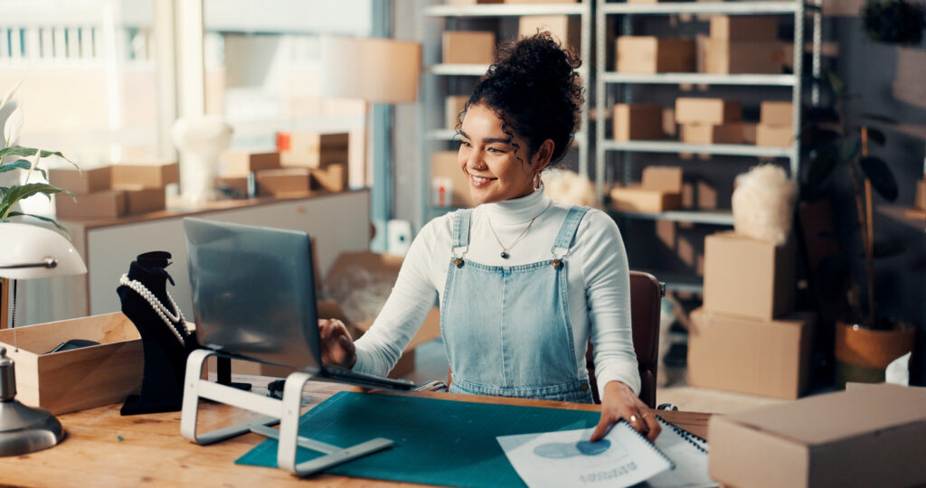 A small business owner working in front of a laptop.