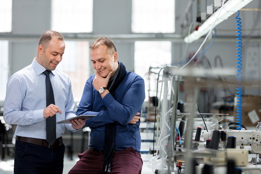 Small business owners looking at a clipboard.