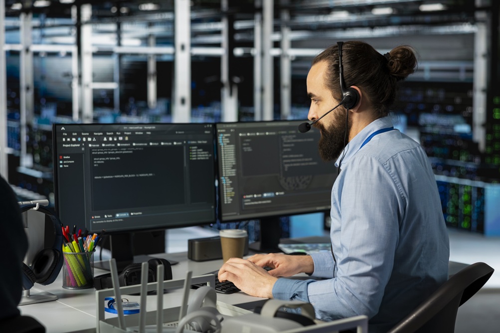 Man doing tech support in server room.