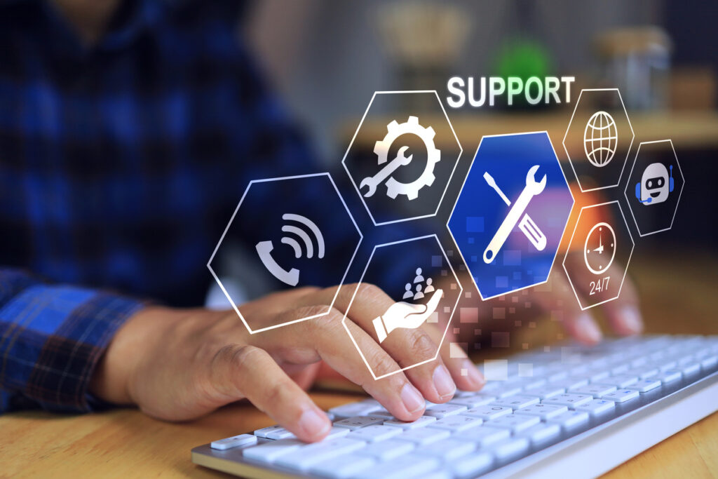 A person typing on a keyboard with an overlay of IT support graphics.