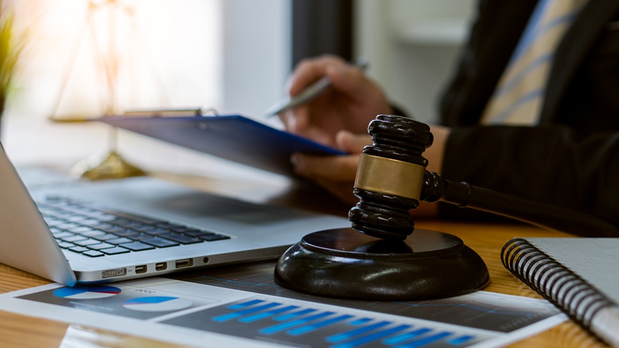 A legal professional working in front of a laptop. 