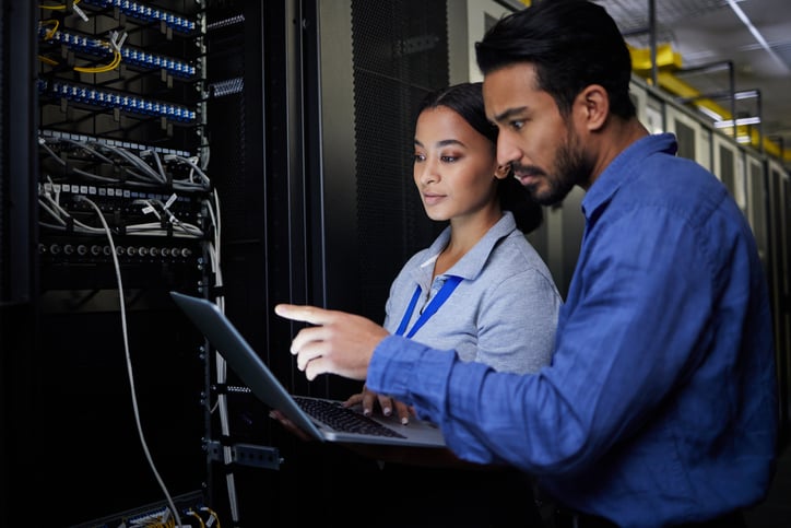 IT professionals working in a server room.